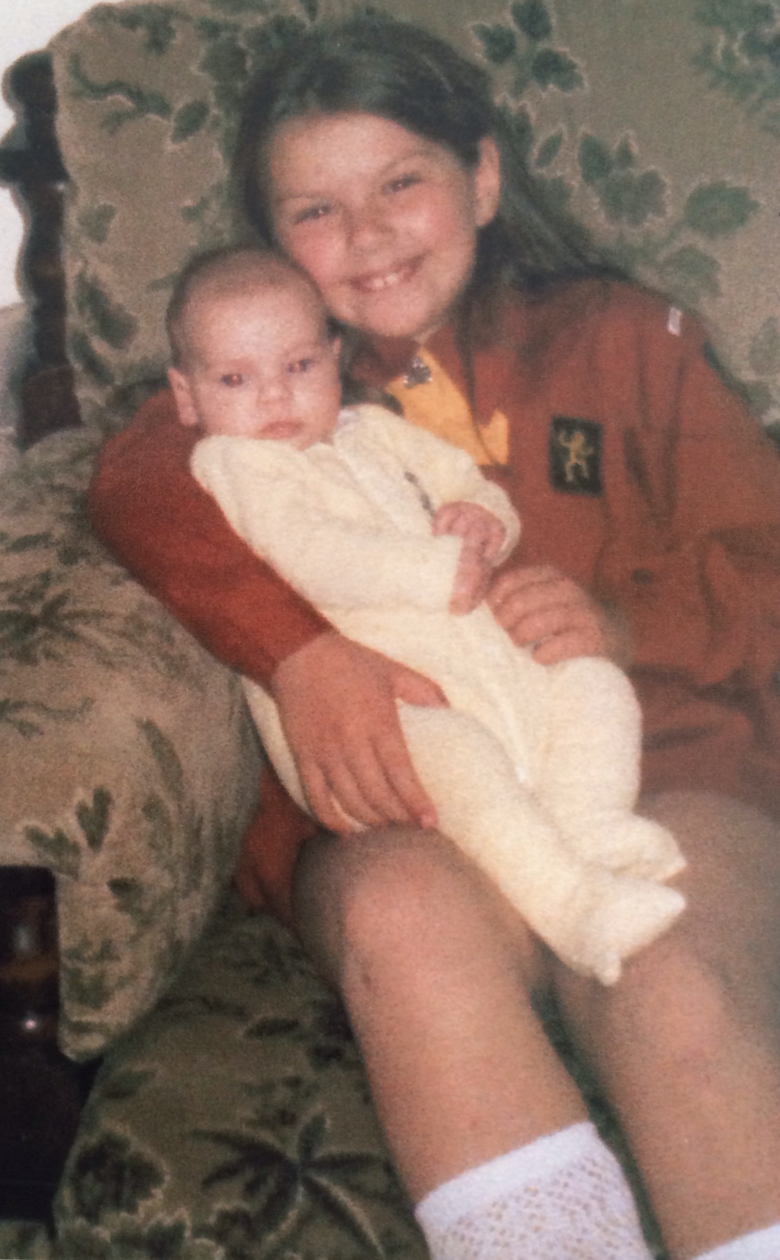 Yes this is me in my Brownie Uniform, minus the brown bobble hat! The baby is my sister Laura!