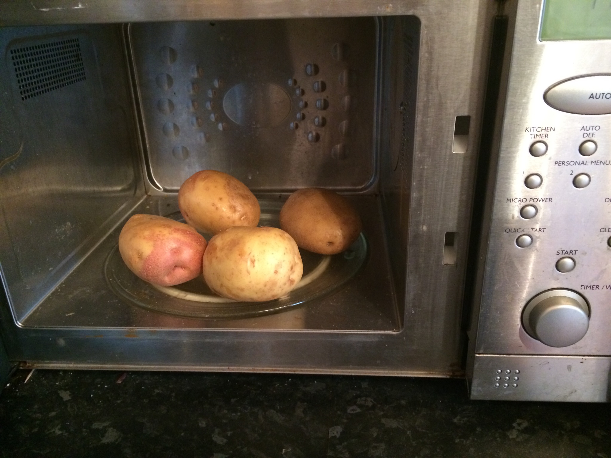Pop the potatoes in the microwave, whole, for about 6-7 minutes. You want them just underdone.