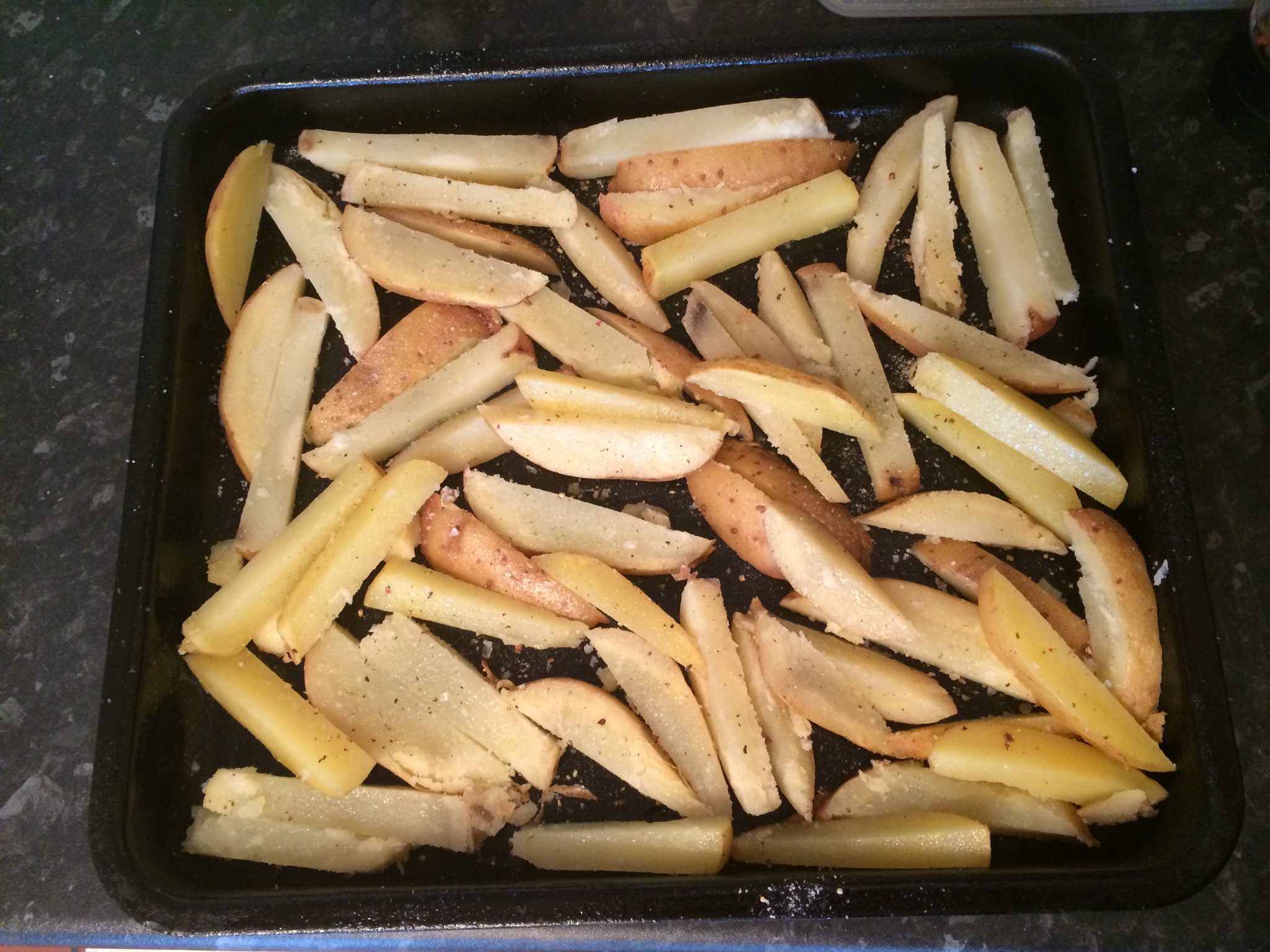Put chips on a baking tray spayed with FryLight. Don't worry if they wont quite all fit in one layer, they shrink while cooking. Spay with Frylight and add whatever seasonings you like. I most often use sea salt and pepper, but another favourite is garlic salt.