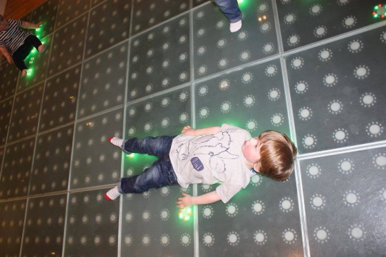 Oscar taking a rare moment of rest on the light up disco floor. I chose the "light up when you step on it" setting and the kids loved it!