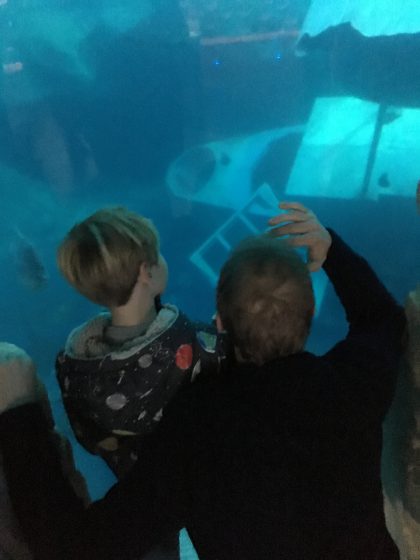 father and son at aquarium